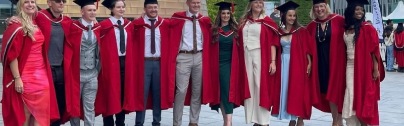 Group photo of 2024 Teesside chiropractic graduates in their graduation gowns.