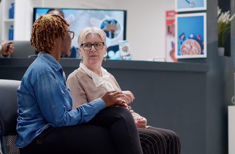 Two seated women having a conversation